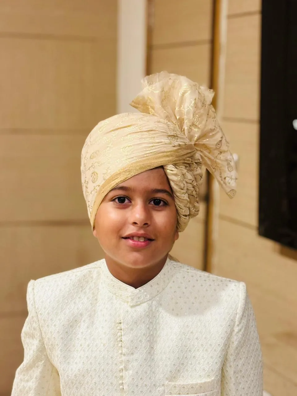 Cream-gold Rajasthani safa style portrait for wedding and family celebration inspiration