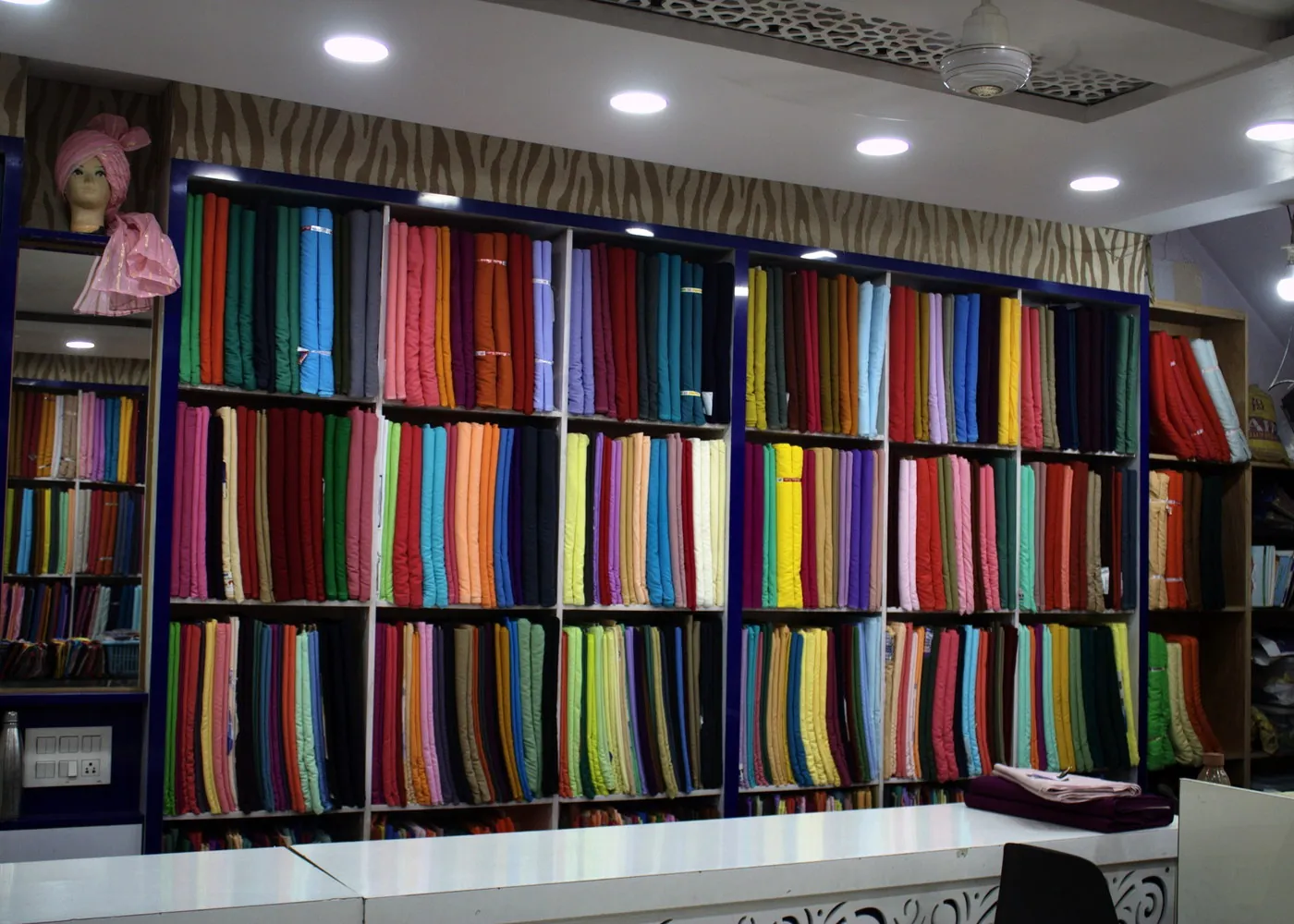 Colourful premium turban fabric rolls displayed inside SAHNEY PAGRI HOUSE