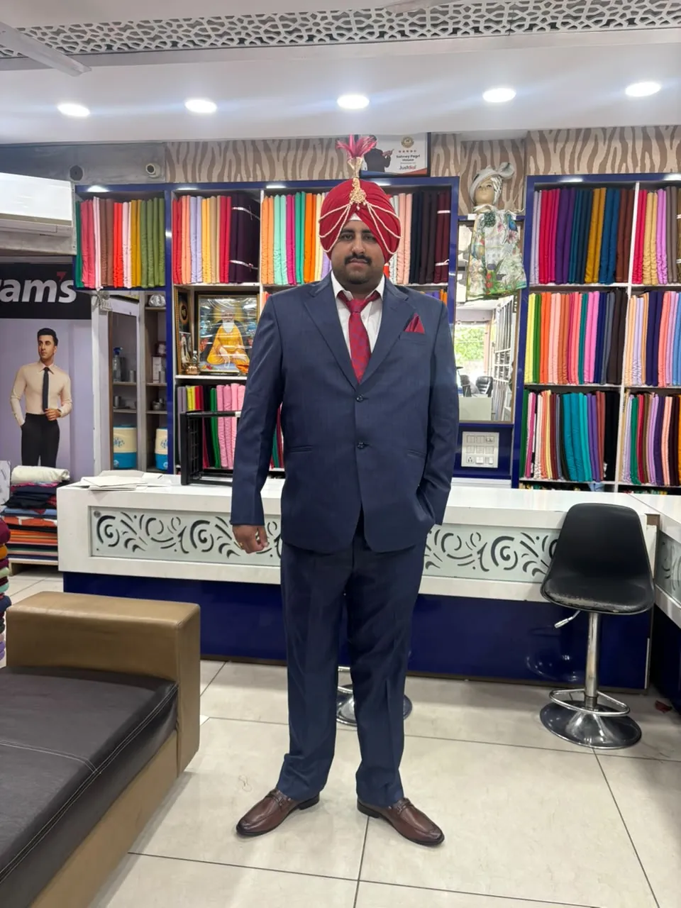 Groom wearing a ceremonial red safa inside Sahney Pagri House